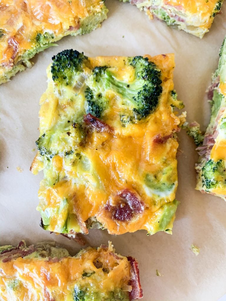 a close up shot of a slice of egg casserole
