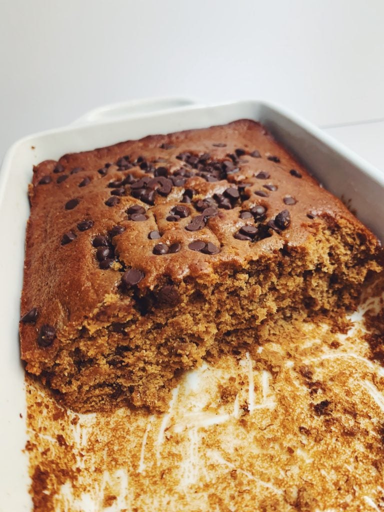 classic chocolate chip banana bread in baking pan on white board