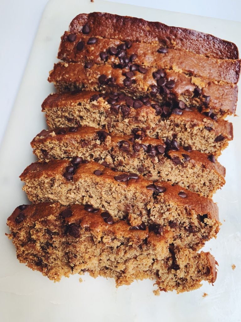 sliced classic chocolate chip banana bread on a white board