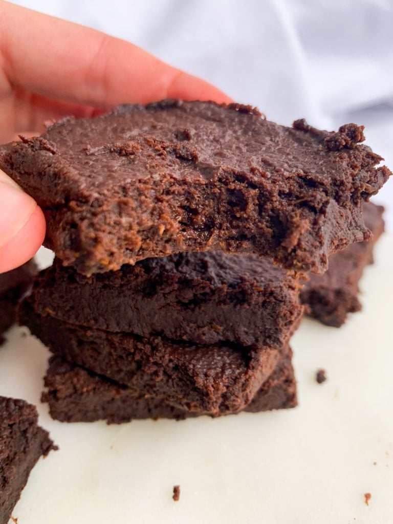 a hand holding one of the paleo sweet potato brownies