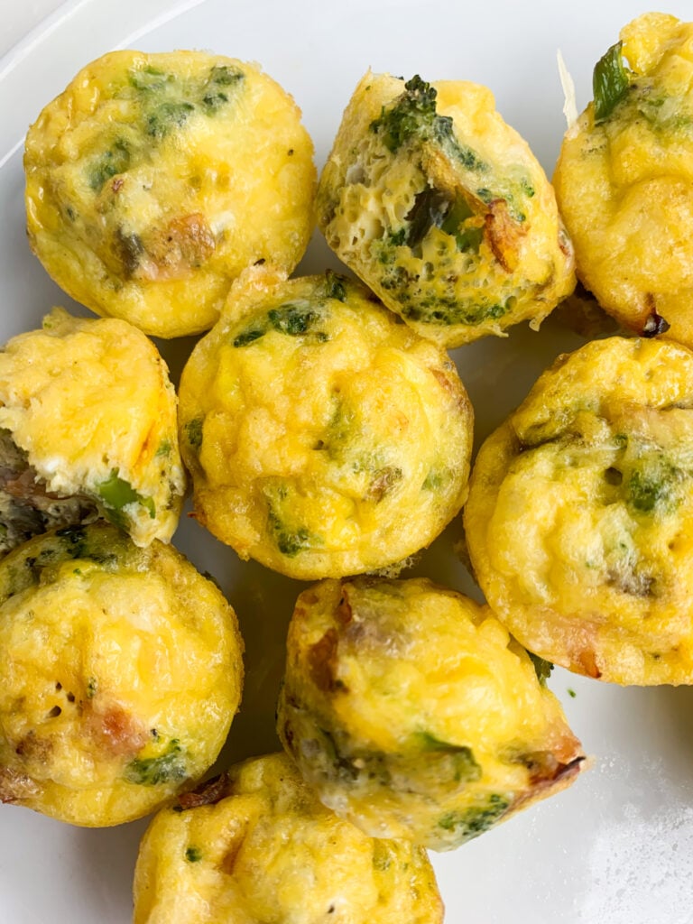 ham, swiss, and broccoli egg bites on a white plate