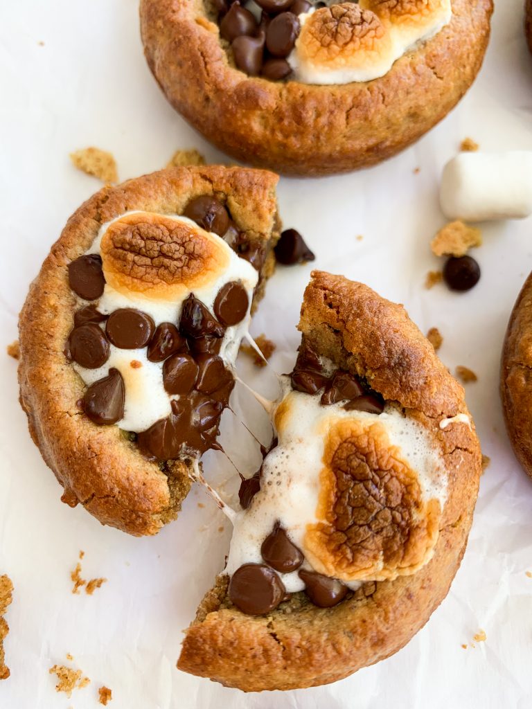 a s'mores cookie cup being pulled apart with gooey marshmallow