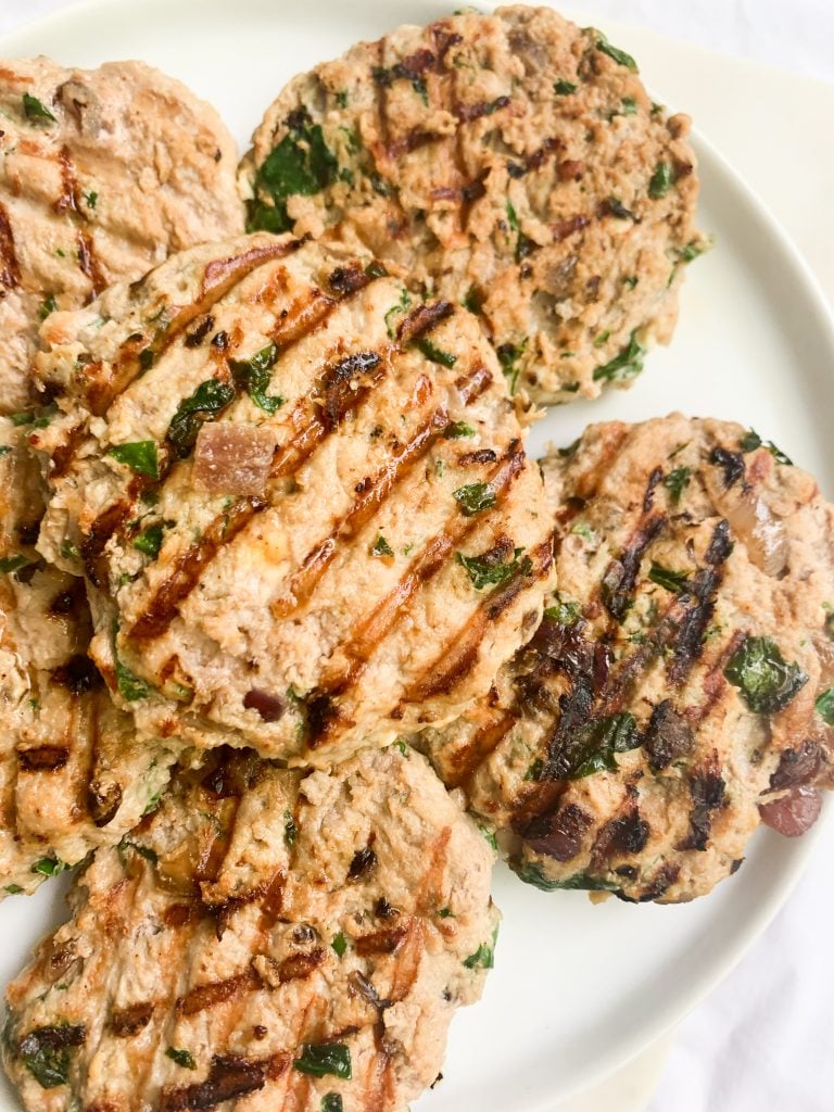 white plate of grilled turkey burgers