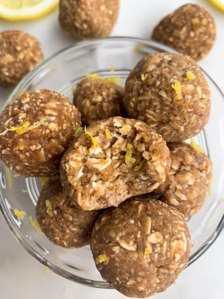 lemon oatmeal energy balls in a glass bowl over a white background