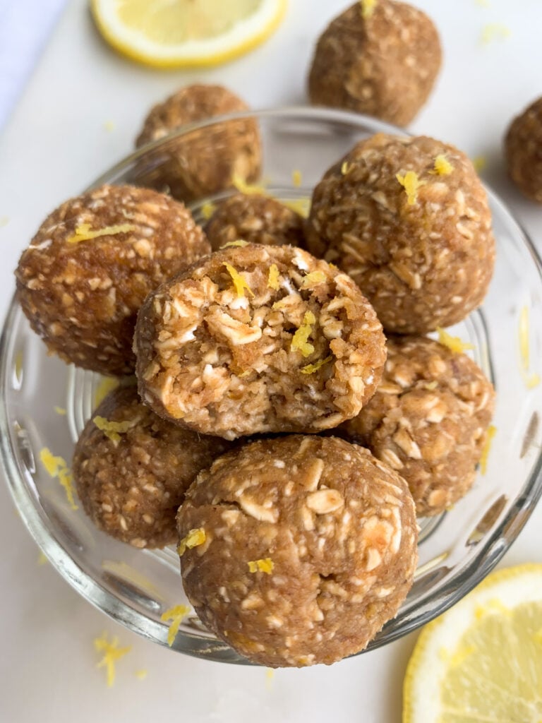 lemon energy oatmeal balls in a white bowl over a white background