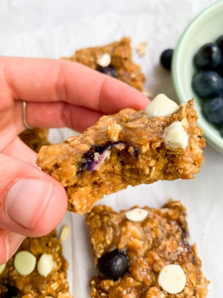 an oatmeal cookie bar with a bite taken out of it 