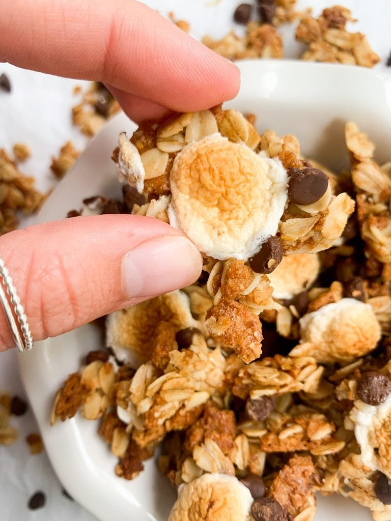 a hand holding one of the granola chunks