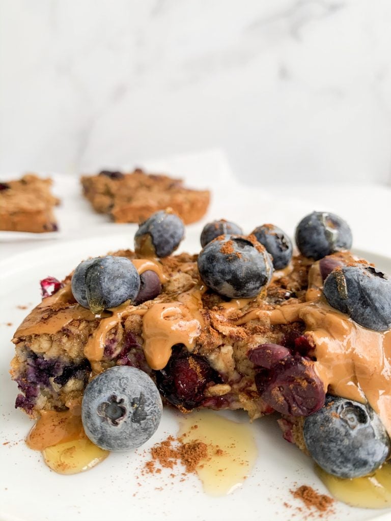 peanut butter banana baked oatmeal with blueberries and extra peanut butter on top 
