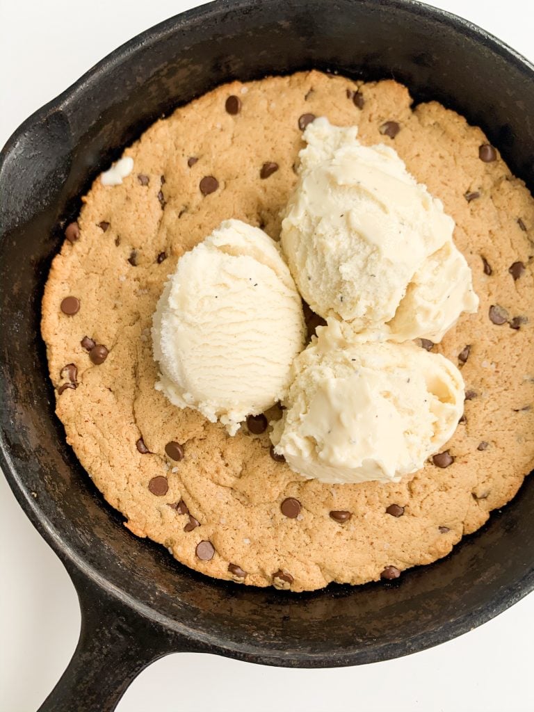 cookie skillet with three scoops of vanilla ice cream on top 