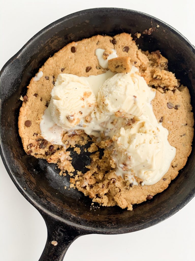 overview shot of chocolate chip cookie skillet, melted ice cream on top