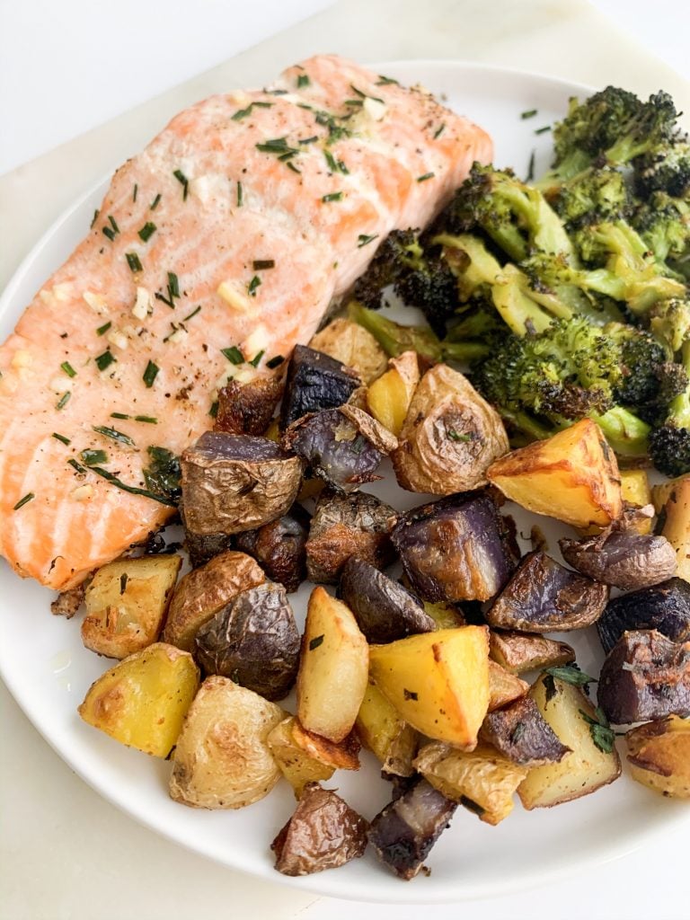 white plate of baked salmon, potatoes, and broccoli