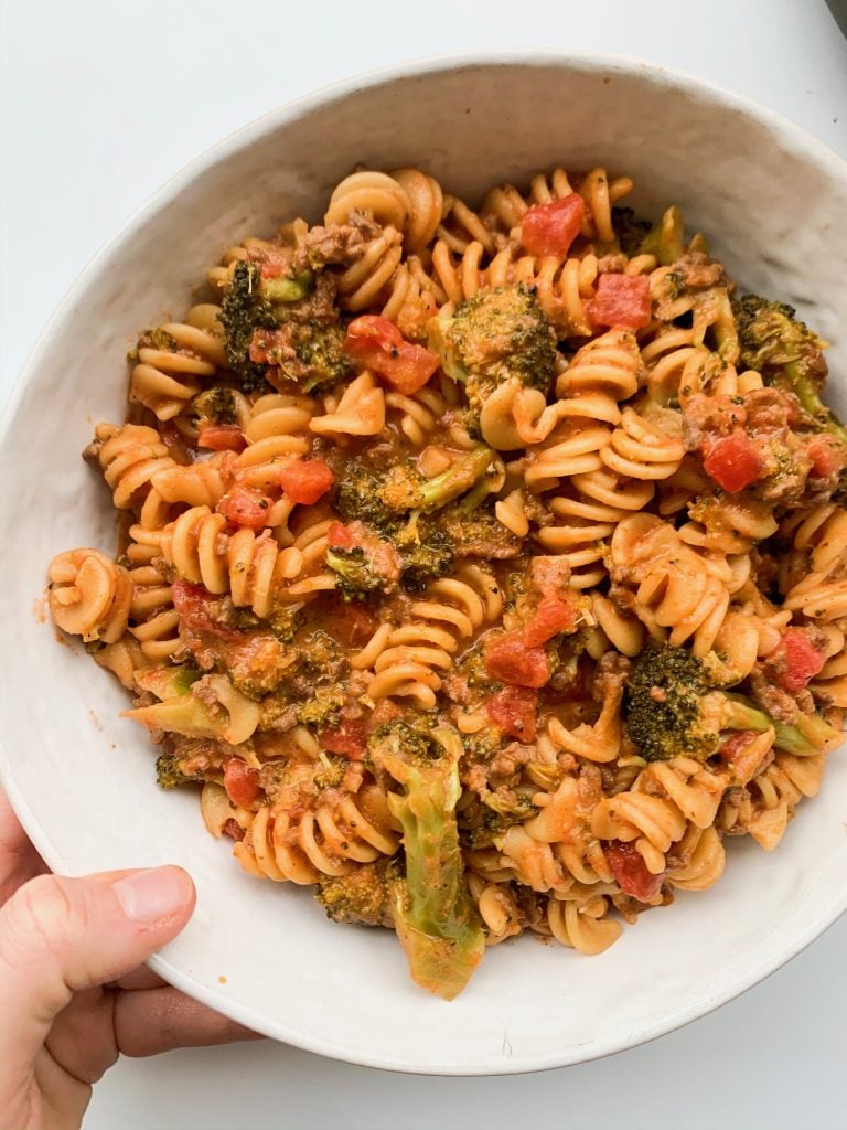 white bowl of ground beef, broccoli, and tomato sauce pasta