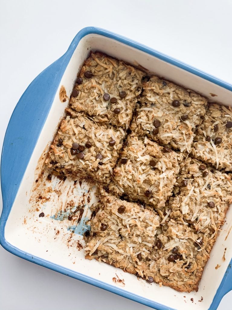 baked oatmeal in a blue baking dish with one square taken out 