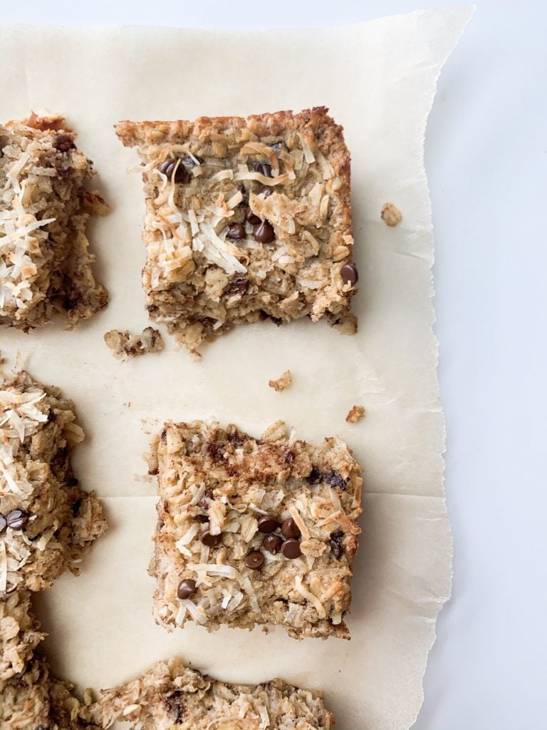 oatmeal bake squares on parchment paper on a white background