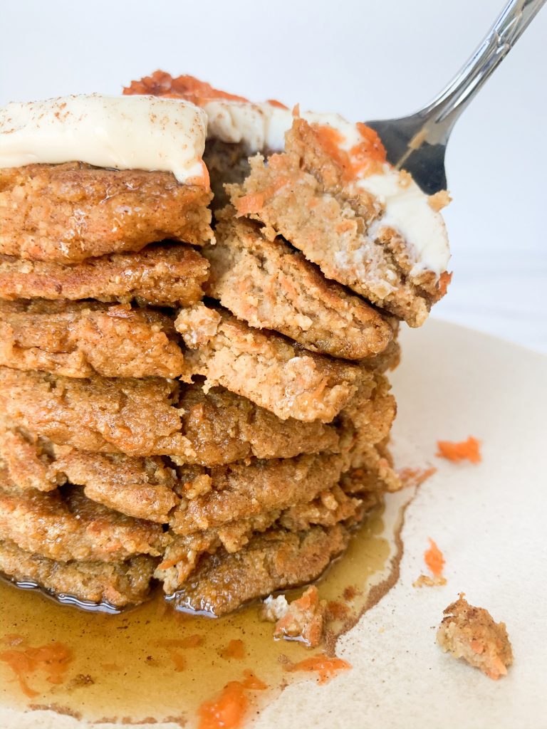 carrot cake pancakes with a fork taking a bite