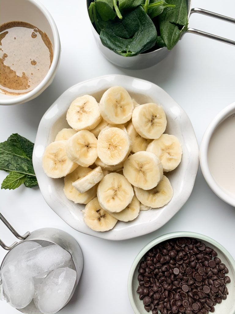 mint chip smoothie ingredients laid out on a white surface