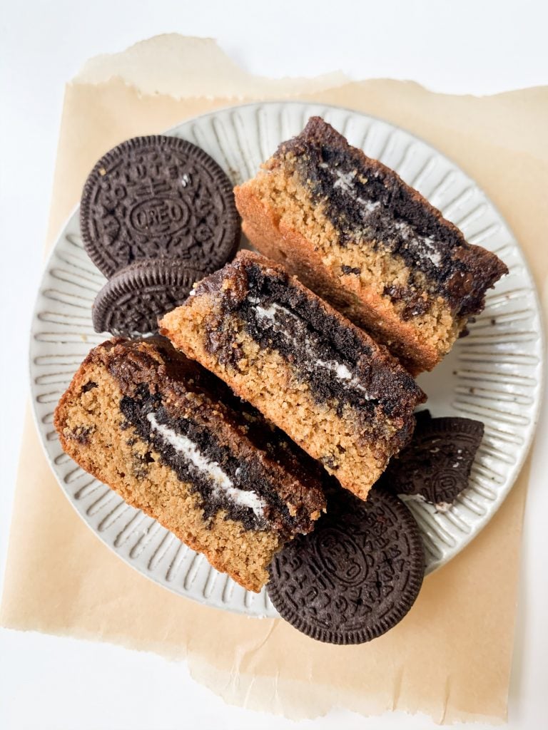 three oreo brownies on a gray plate on parchment paper
