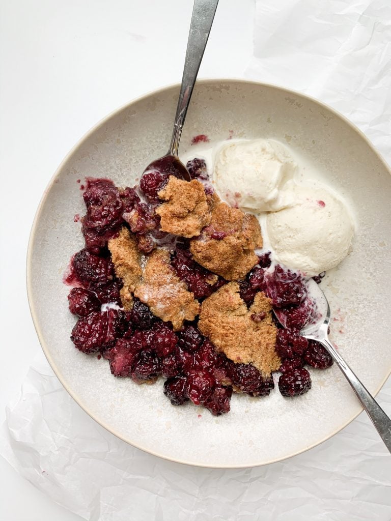 healthy blackberry cobbler in a bowl with ice cream 