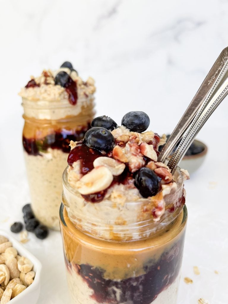 overnight oats jar with two spoons taking a bite out
