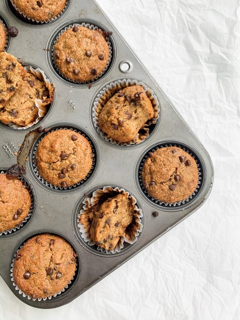 banana muffins in the muffin tin on a white background
