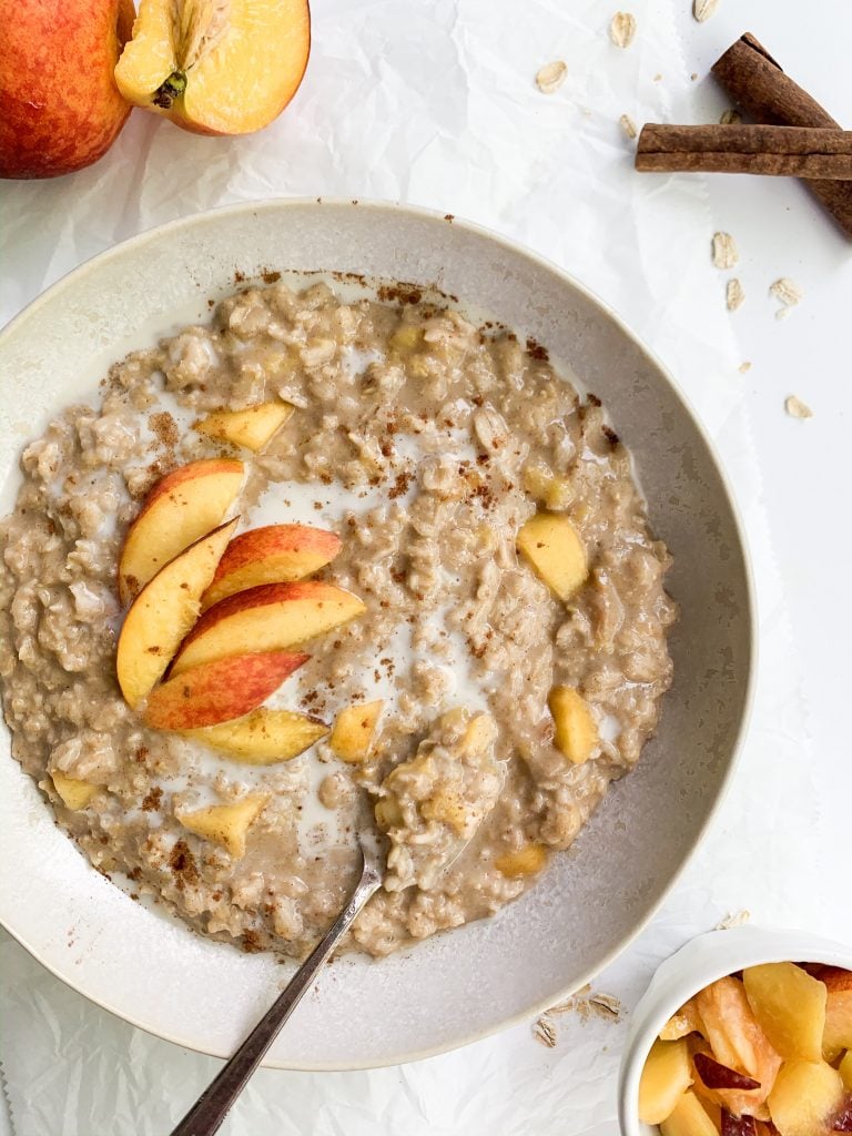 peach oatmeal with peaches, cinnamon, and oats on the side