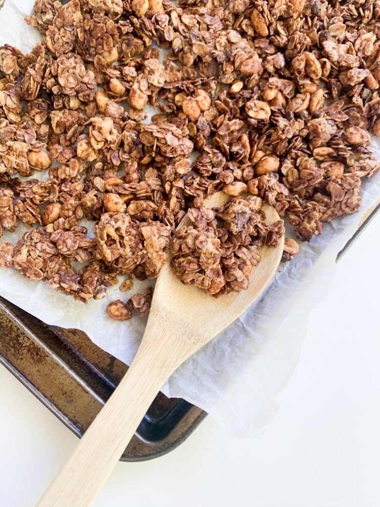 close up shot of peanut butter granola with a wooden spoon