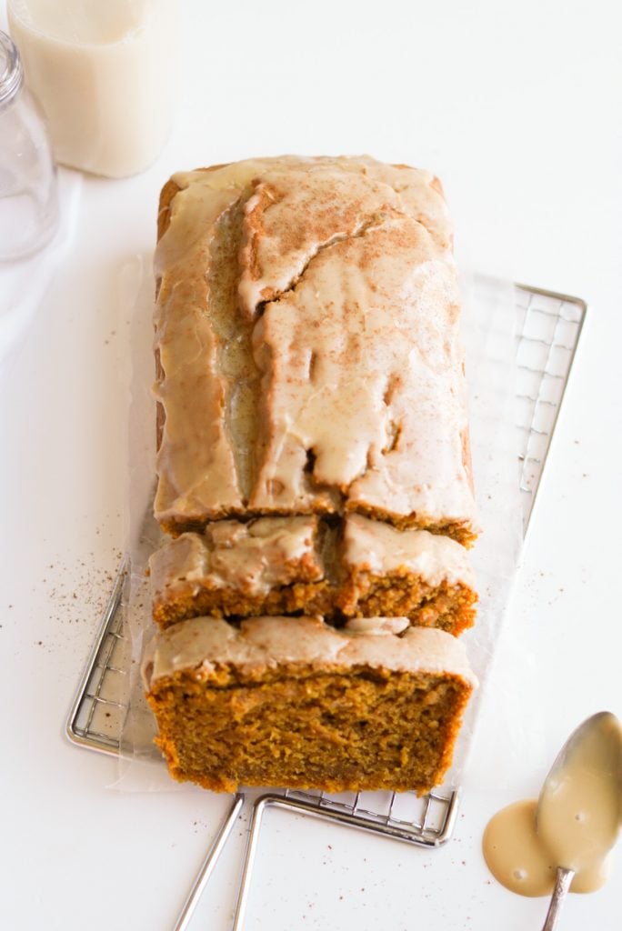 overhead shot of Moist Pumpkin Bread with maple glaze on a cooling rack.