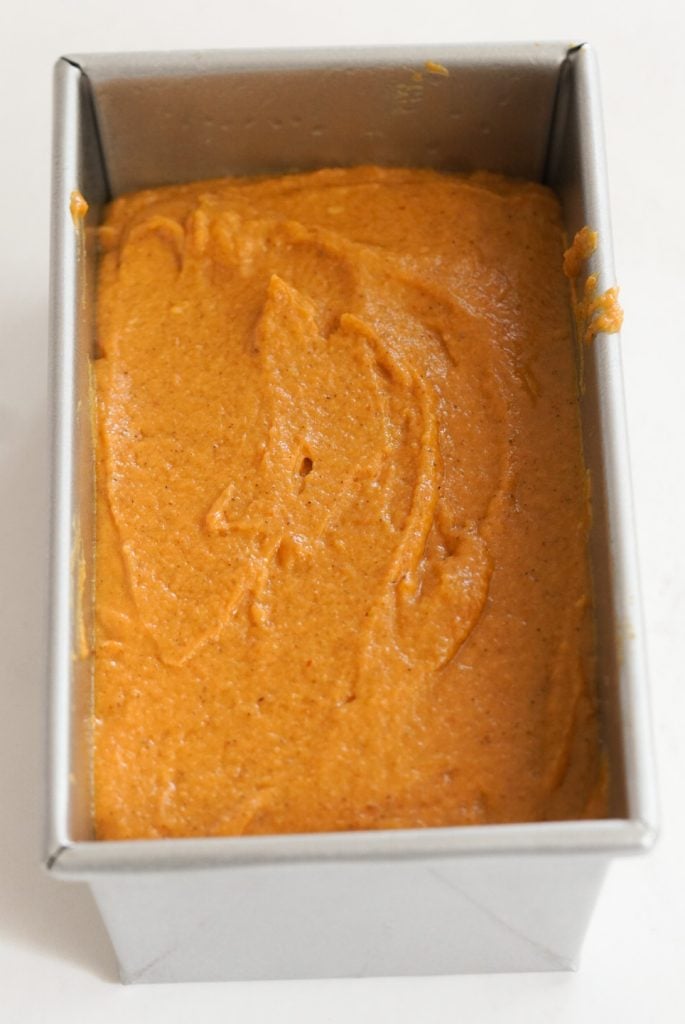 pumpkin bread batter in a loaf pan