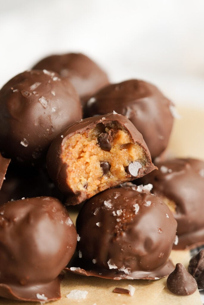 closeup shot of salted chocolate chip cookie dough bites on a brown parchment paper  background