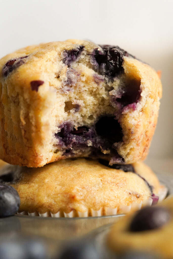 closeup of two stacked muffins with blueberries