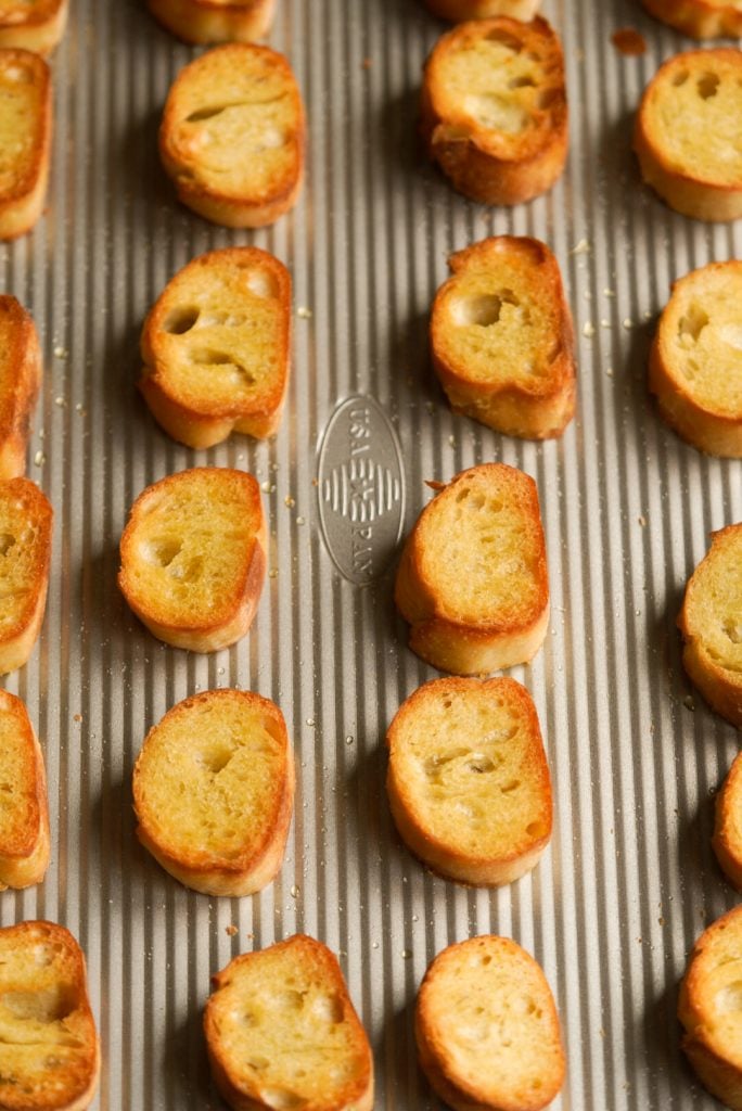 toasted french baguette slices on a baking tray