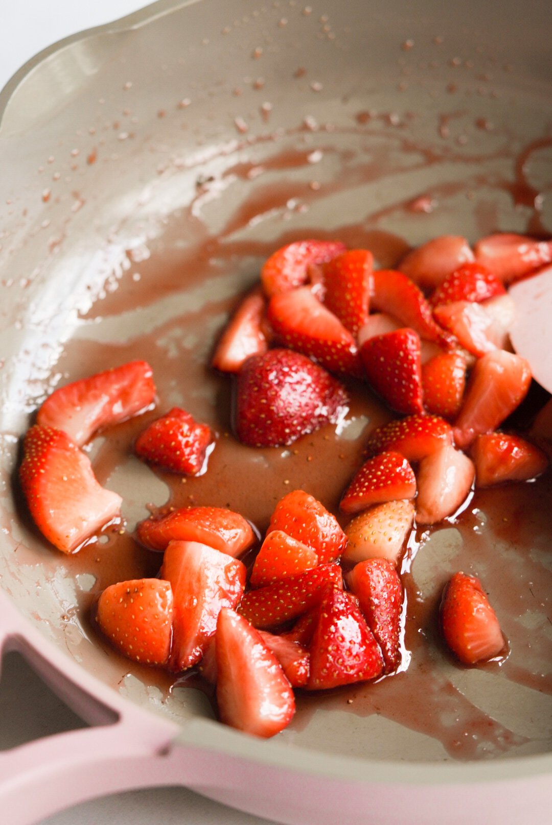strawberries and maple syrup in a pan