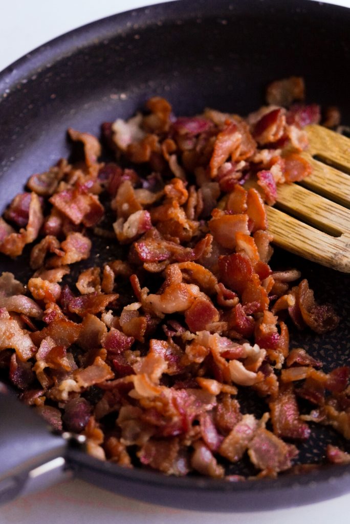 cooked bacon pieces in a pan