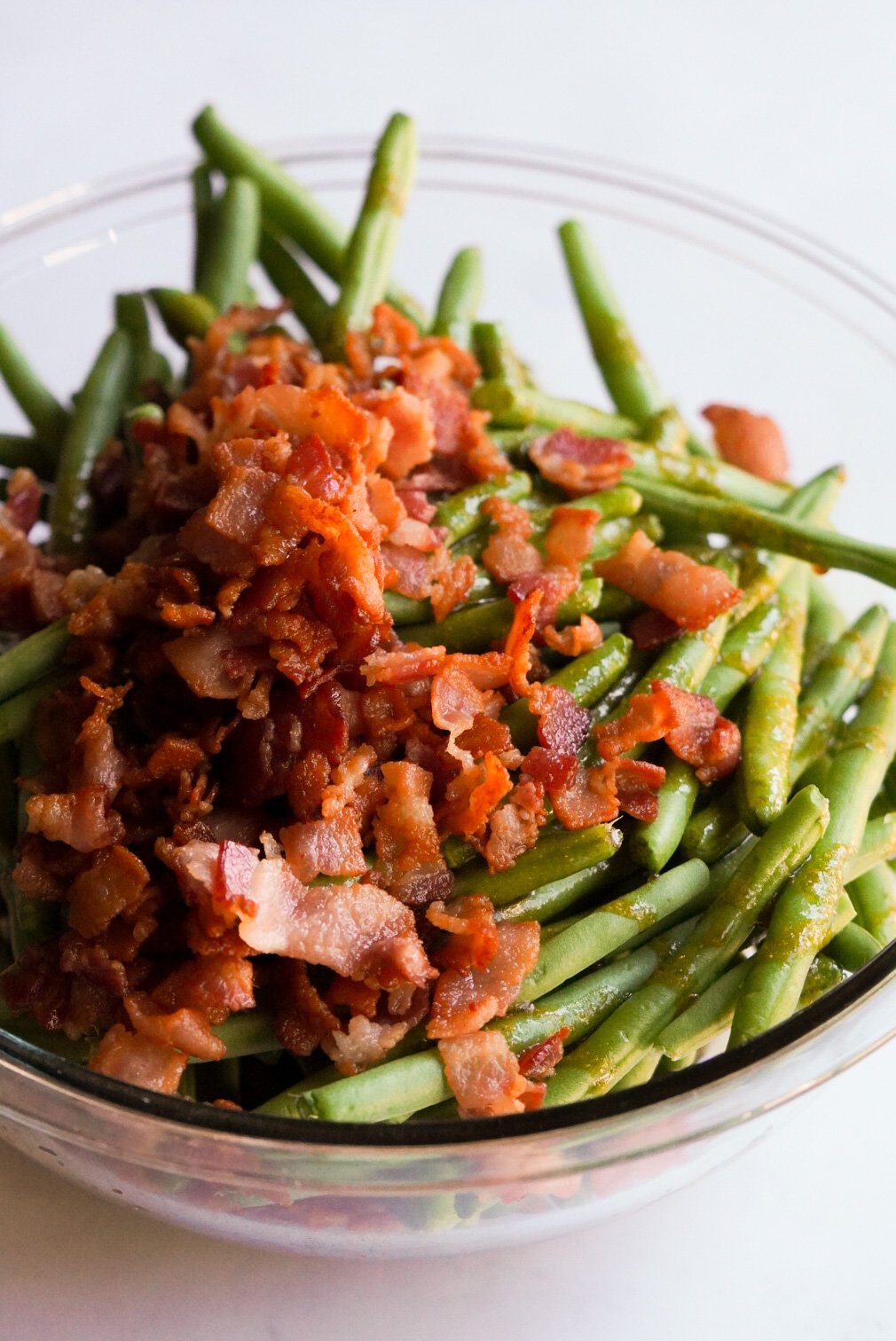 green beans, bacon, and crack sauce in a mixing bowl