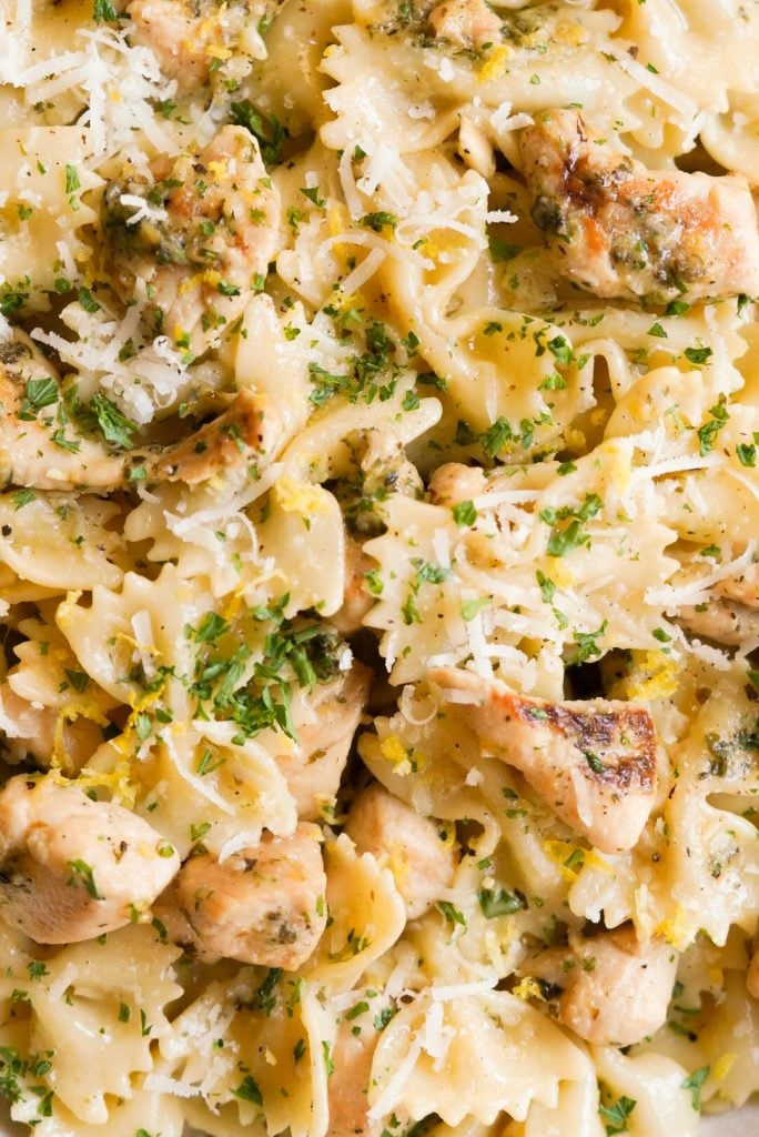 close up shot overhead shot of pasta with lemon, chicken, parmesan cheese, and parsley