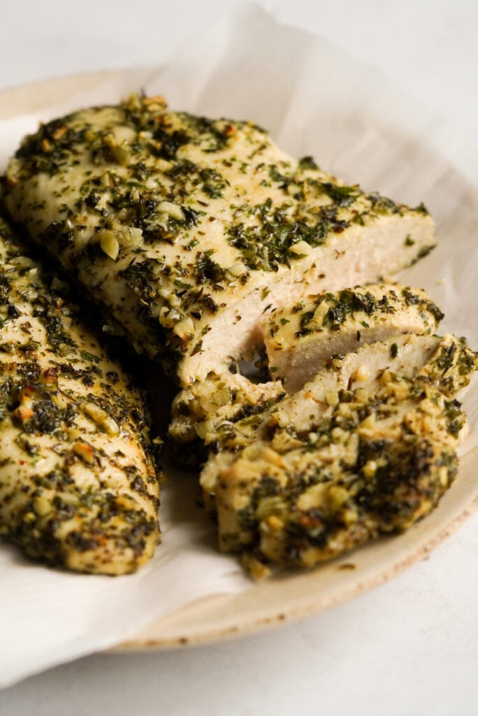 oven baked greek chicken on a plate with parchment paper