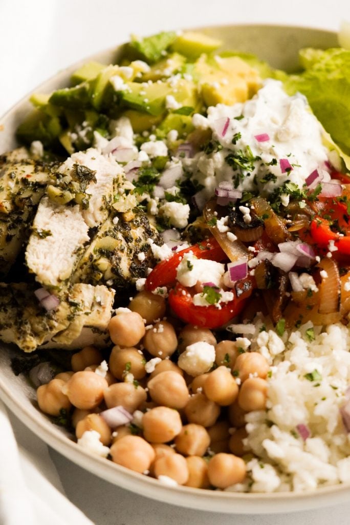 Mediterranean rice bowl with chicken, rice, feta, veggies, and more