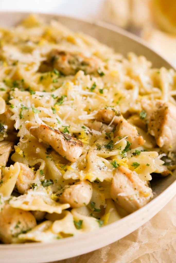 bowl of creamy lemon chicken pasta with fresh parsley and parmesan cheese