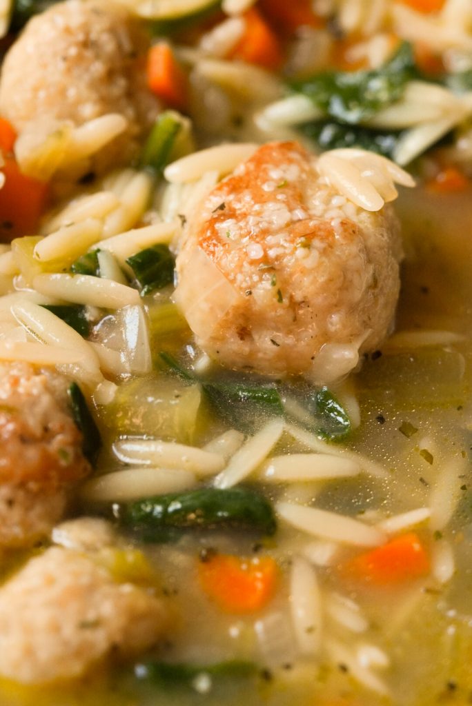 close up shot of a meatball in vegetable soup