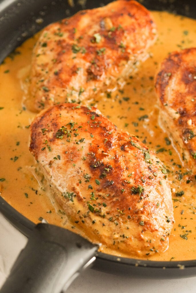 creamy herb chicken in a large pan