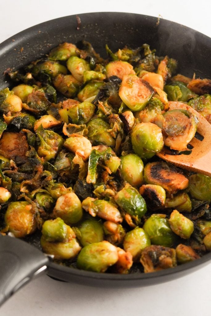 glazed sriracha honey brussel sprouts in a pan