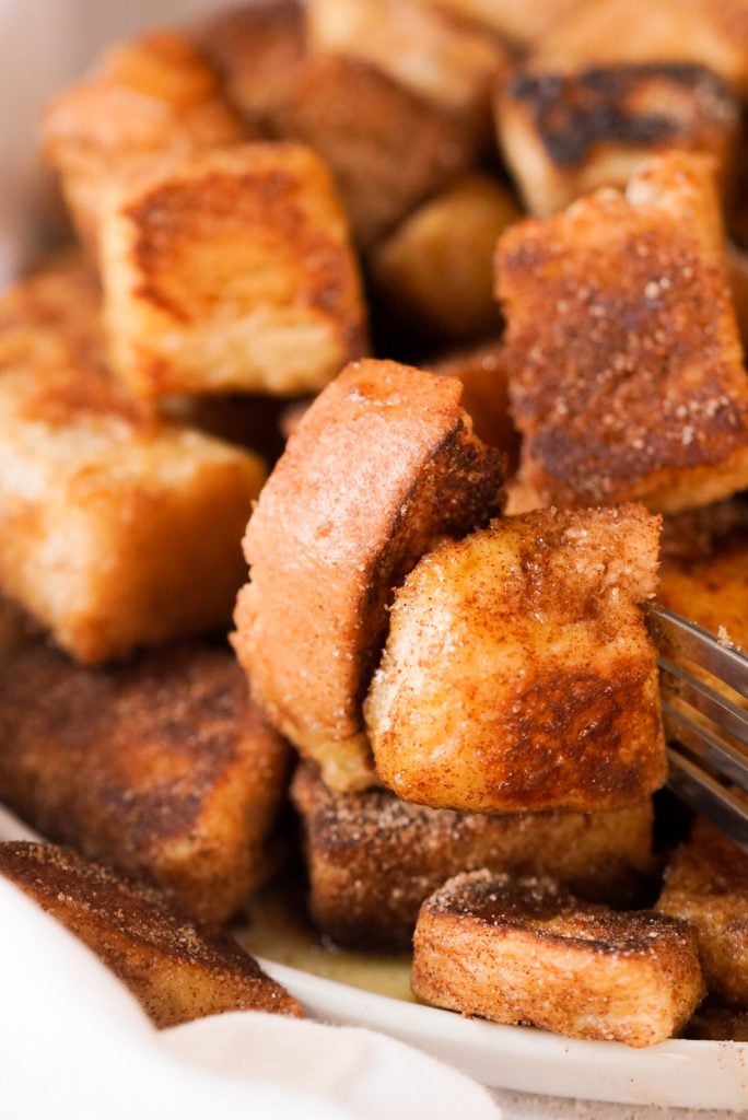 french toast bites with a fork taking one