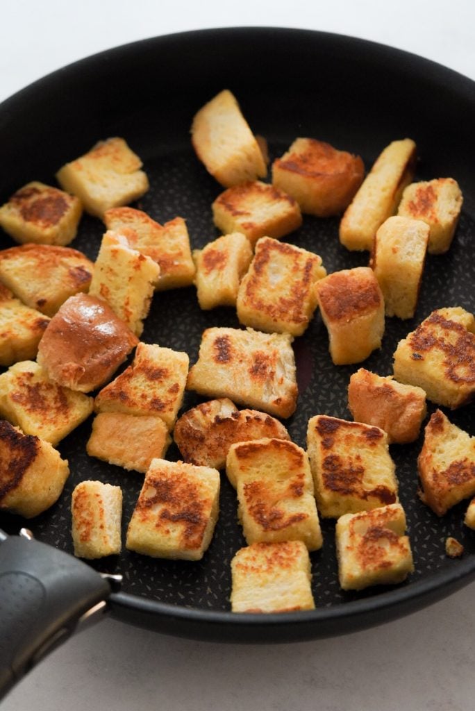 bread cubes being pan fried