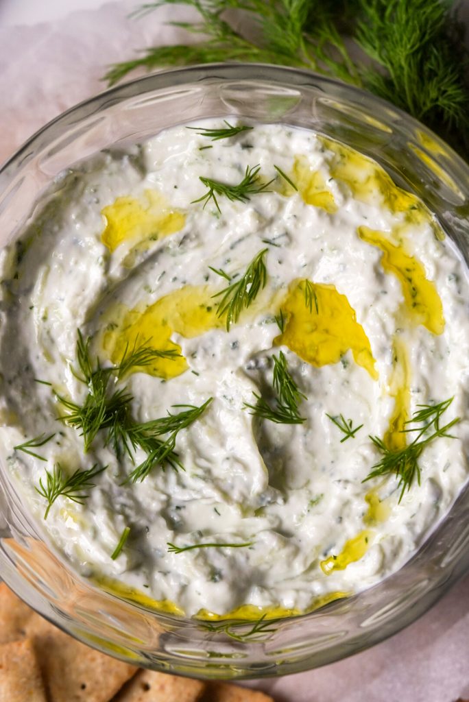 cucumber dill tzatziki topped with olive oil and fresh dill
