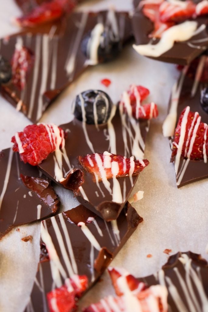 dark chocolate pieces with berries and white chocolate on top