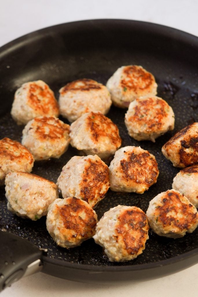 greek chicken meatballs in a pan