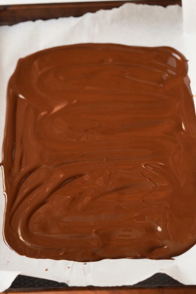 melted dark chocolate spread on a cookie sheet