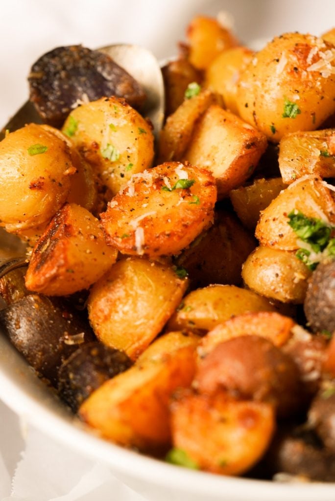 parmesan garlic roasted potatoes with parmesan cheese and fresh parsley on top