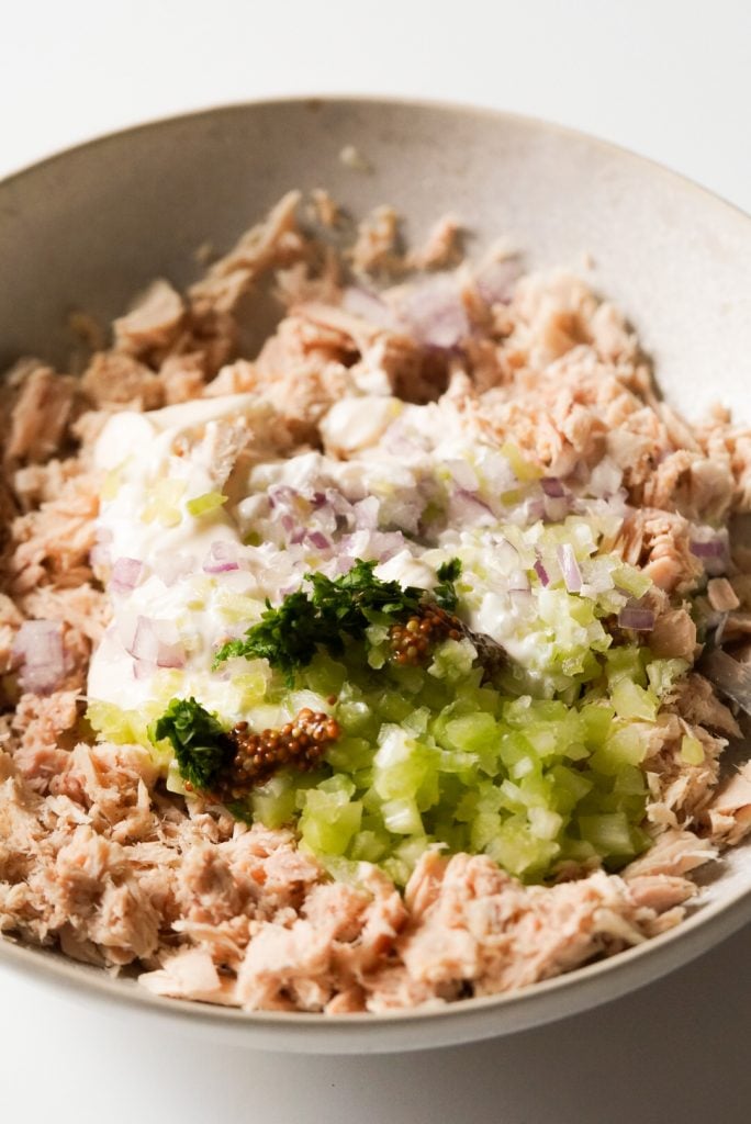 tuna fish, mayo, red onion, celery, fresh parsley, and whole grain mustard in a bowl