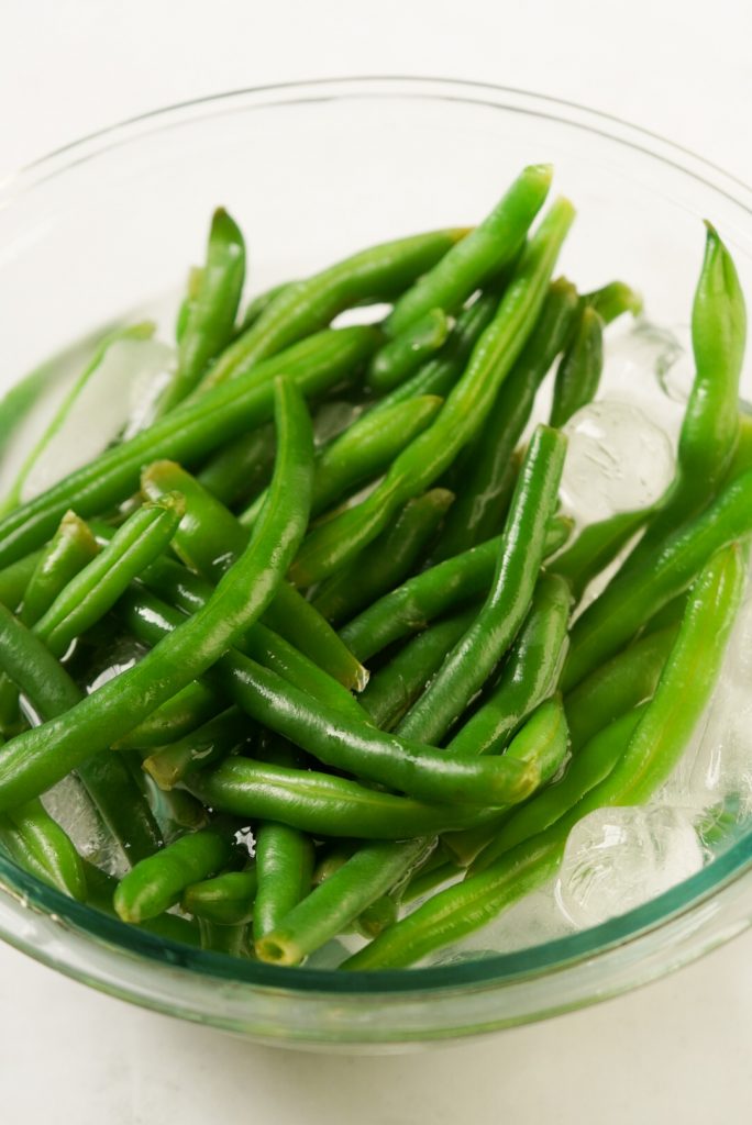 blanched green beans in a ice bath